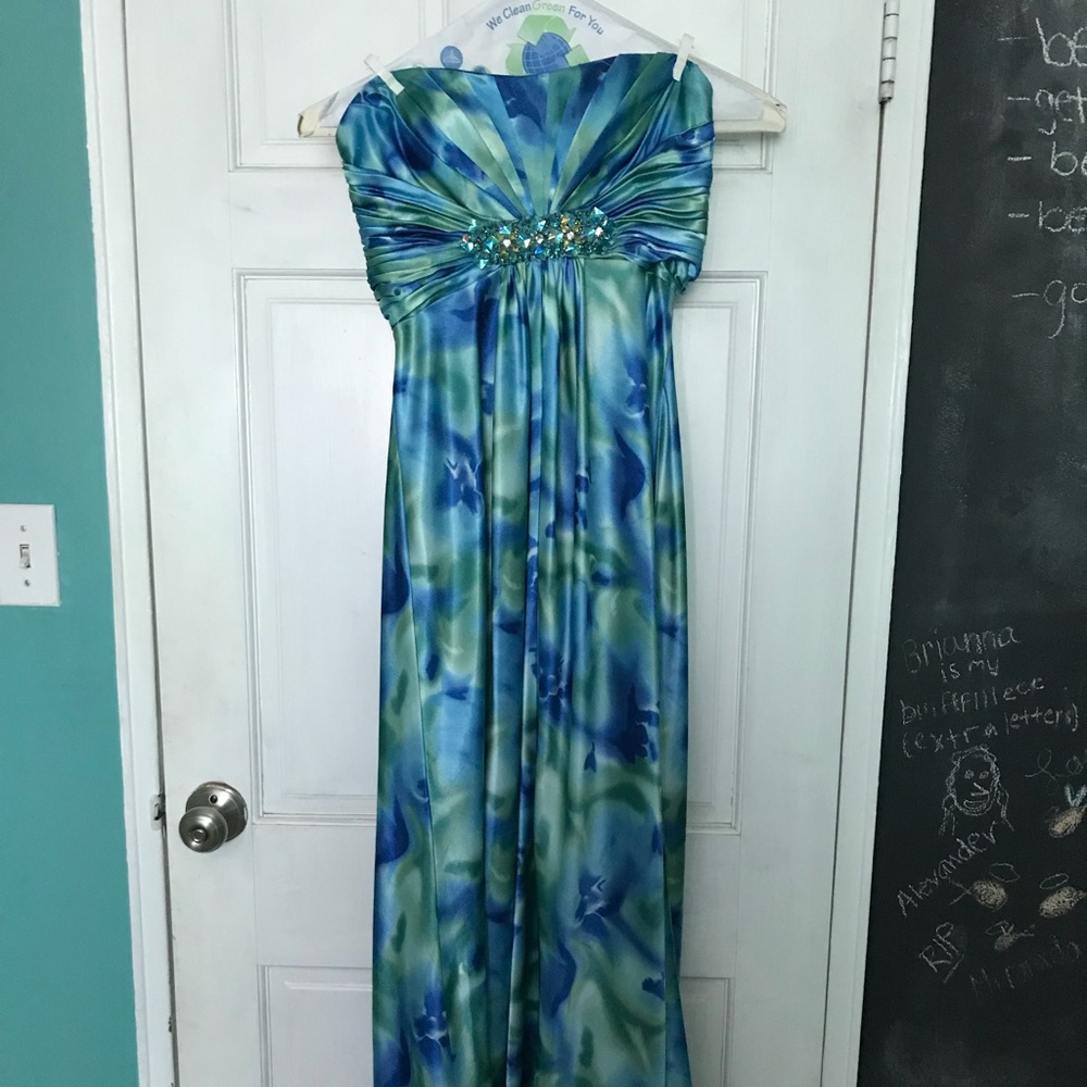 Floor length blue and green gown.